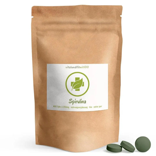 Spirulina bio, 100 g: busta marrone accanto a compresse verdi.
